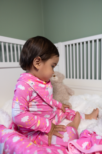 Baby in crib wearing a pink Kibby bamboo pyjamas