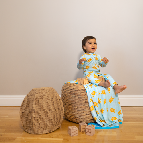 Ahoy Mr Crab Baby sitting on a blue blanket wearing a Kibby bamboo pyjamas