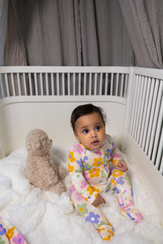 Toddler wearing a Kibby bamboo pyjamas in a white crib