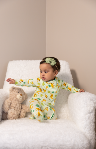 Safari Toddler sitting in an armchair wearing a safari bamboo pyjamas